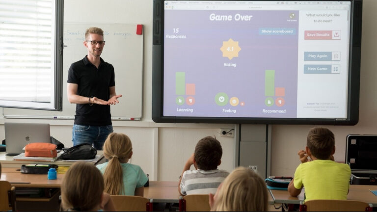 Interactive Flat Panel in a classroom, with the teacher teaching.